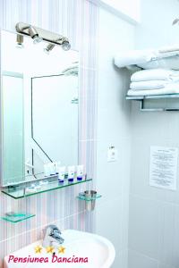 a bathroom with a sink and a mirror at Pension Daciana in Bacău