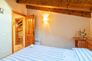 a bedroom with a bed with a light on the wall at Casa con encanto en la Cerdaña Francesa in Estavar