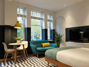 a living room filled with furniture and a tv at Student Castle - Studio Apartments in Bath