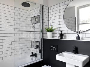 a bathroom with a sink, toilet and mirror at Student Castle - Studio Apartments in Bath