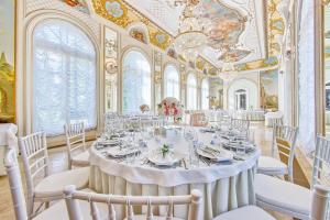 a dining room with a large table and chairs at Palace Yelizavetino in Dylitsy