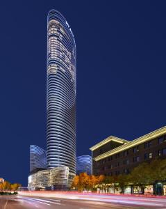 a tall skyscraper with a street in front of it at Hyatt Regency Xuzhou in Xuzhou