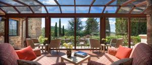 a living room filled with tables and chairs at Castello di Spaltenna Exclusive Resort & Spa in Gaiole in Chianti