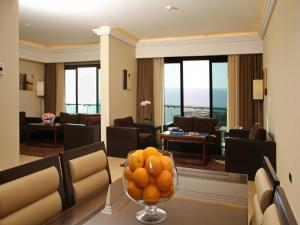 a living room with a bowl of oranges on a table at Lancaster Suites Raouche in Beirut