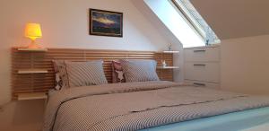 a bedroom with a large bed with a window at Yellow apartma Kranjska Gora in Kranjska Gora