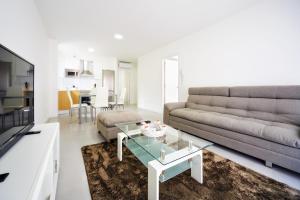 a living room with a couch and a coffee table at Rueiro 17 in A Coruña