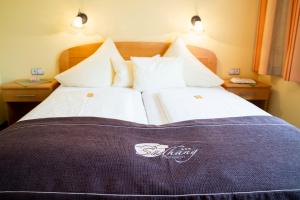 a bedroom with a large bed with a purple blanket at Pension Südhang in Bad Kleinkirchheim