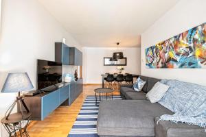 a living room with a couch and a table at Apartamento lujo& piscina junto Barcelona Centro in Ripollet
