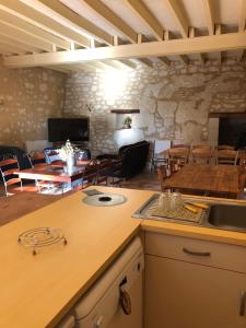 a kitchen and dining room with a table and chairs at Logis de Poëllier in Baugé-en-Anjou