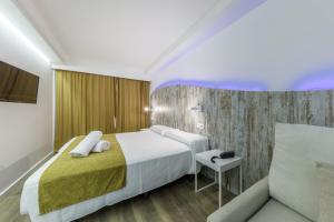 Łóżko lub łóżka w pokoju w obiekcie Welikehotel Triton Beach