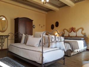 a bedroom with a bed and a couch in it at Cappone B&B in Morciano di Romagna