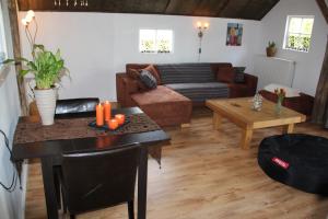 a living room with a table and a couch at B&B In de Backerije in Zuidwolde