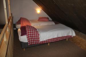 two twin beds in a room with a attic at B&B In de Backerije in Zuidwolde