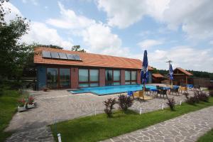 a house with a swimming pool in front of it at Areal Botanika in Unhošť