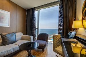 a living room with a couch and a table at Lancaster Plaza Beirut in Beirut