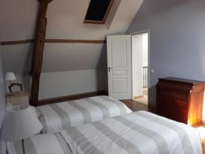 a bedroom with two beds and a dresser in it at Gite La Vigneronne en Touraine in Saint-Georges-sur-Cher
