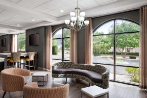 a living room with a couch and chairs at Days Inn & Suites by Wyndham Murfreesboro in Murfreesboro