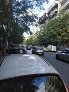 a car driving down a city street with cars at TONI'S Lovely Retreat Studio for couples in Centre in Athens