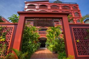 una entrada al complejo con un edificio rojo en Bou Savy Villa, en Siem Reap