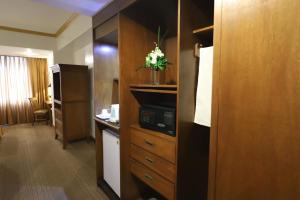 a hotel room with a kitchen and a room at Tiara Oriental Hotel in Manila