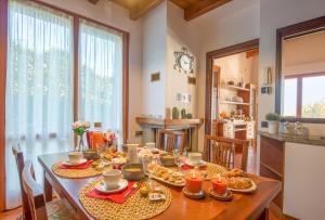 a dining room with a table with food on it at Villa Principessa in Cremia