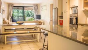 a kitchen with a table and a counter top at 6 The Village, Hout Bay in Hout Bay