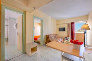 a hotel room with a bedroom and a living room at Pavlos Hotel in Kos Town