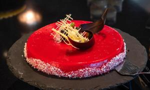 a red cake sitting on top of a table at Thon Hotel Opera in Oslo