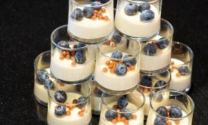 a group of glasses filled with yogurt and blueberries at Thon Hotel Opera in Oslo