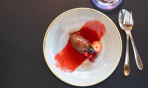 a plate of food with fruit and sauce on a table at Thon Hotel Opera in Oslo