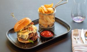 a tray with a sandwich and french fries on a table at Thon Hotel Opera in Oslo