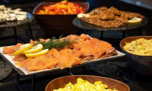 a plate of fish and other food on a table at Thon Hotel Opera in Oslo