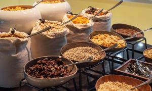 a table with many bowls of different types of food at Thon Hotel Opera in Oslo