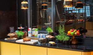 a buffet with food and fruits on a counter at Thon Hotel Opera in Oslo