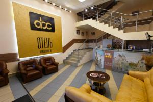a waiting room with couches and chairs and stairs at Hotel ABC in Penza