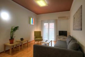 a living room with a couch and a tv at Your home @Acropolis Museum in Athens