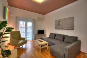 a living room with a couch and a chair at Your home @Acropolis Museum in Athens