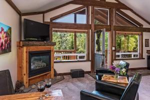 a living room with a fireplace and a tv at Carson Ridge Luxury Cabins in Carson