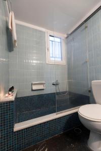 a bathroom with a glass shower and a toilet at Your home @Acropolis Museum in Athens