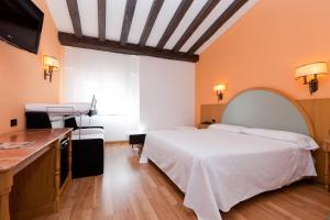 a hotel room with a bed and a sink at Gran Hotel Los Angeles in Getafe +35 photos