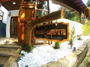 a sign for a restaurant in front of a building at Pousada Guapuruvu in Abraão