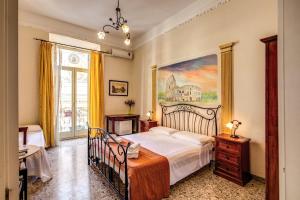 a bedroom with a bed and a painting on the wall at Magenta Collection Manara 4 in Rome