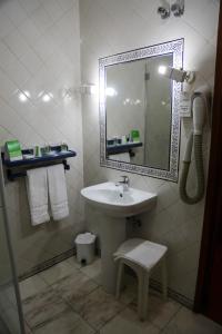 a bathroom with a sink and a mirror at INATEL Castelo De Vide in Castelo de Vide