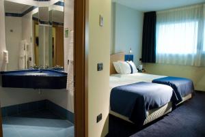 Postel nebo postele na pokoji v ubytování Hotel Mastai