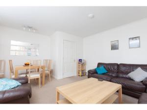 a living room with a couch and a table at Attractive Edinburgh Leith Apartment in Edinburgh