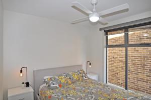 a bedroom with a bed and a ceiling fan at SUNSET WATERS - INLET SIDE in Inverloch