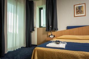 Postel nebo postele na pokoji v ubytování Hotel Mastai