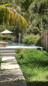 a swimming pool with a picnic table and a bench at Hotel Tropicana in Svitlovodsʼk