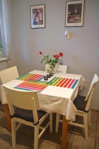 a dining room table with a colorful table cloth on it at Cherry Tree Guest House in Gdańsk