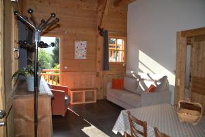 a living room with a couch and a table at Chalet des fleurs in Samoëns